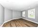 Bright, spacious living room with modern flooring and natural light from two windows at 1653 S Delaware St, Indianapolis, IN 46225