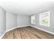 Bright, spacious living room with modern flooring and natural light from two windows at 1653 S Delaware St, Indianapolis, IN 46225