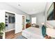 Staged main bedroom with wood floors, light gray walls and a view to closet and bathroom at 1653 S Delaware St, Indianapolis, IN 46225