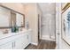 Well-lit bathroom with a double sink vanity and a walk-in shower with glass door at 17220 Cole Evans Dr, Noblesville, IN 46060