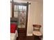 Bathroom with glass door shower stall, red floral shower curtain, and chair at 1921 W Michigan St, Indianapolis, IN 46222