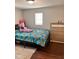 Bright bedroom features a dinosaur-themed bed and a light, four-drawer dresser at 1921 W Michigan St, Indianapolis, IN 46222