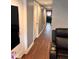 Hallway with laminate flooring, modern doors, and neutral paint at 1921 W Michigan St, Indianapolis, IN 46222