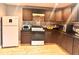 Spacious kitchen with wood cabinets, granite counters, and modern appliances at 1921 W Michigan St, Indianapolis, IN 46222