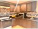 Functional kitchen featuring wood cabinets, granite counters, and modern appliances at 1921 W Michigan St, Indianapolis, IN 46222