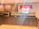 Updated kitchen featuring granite countertops, tiled backsplash, and wood cabinets at 1921 W Michigan St, Indianapolis, IN 46222