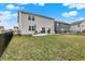 Spacious backyard featuring a concrete patio, black metal fencing, and lush green grass at 19970 Edwick Dr, Westfield, IN 46074