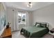 Bright bedroom with a black metal bed, soft carpet, and view to the neighborhood at 19970 Edwick Dr, Westfield, IN 46074