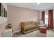 Sweet Bedroom featuring pink walls, soft curtains, a comfy chair, and a wooden crib at 19970 Edwick Dr, Westfield, IN 46074