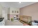 Lovely Bedroom with cute wall decor, a white bookcase, and a classic wooden crib at 19970 Edwick Dr, Westfield, IN 46074