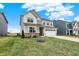 Charming two-story home boasts a two-car garage, a brick foundation, and a well-manicured lawn at 19970 Edwick Dr, Westfield, IN 46074