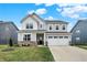 Charming two-story home boasts a two-car garage, a brick foundation, and a well-manicured lawn at 19970 Edwick Dr, Westfield, IN 46074