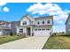 Charming two-story home boasts a two-car garage, a brick foundation, and a well-manicured lawn at 19970 Edwick Dr, Westfield, IN 46074