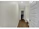 Hallway leading to a powder room, featuring a built-in bench and modern design at 19970 Edwick Dr, Westfield, IN 46074
