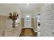 Inviting hallway with elegant wainscoting, wood floors, and decor at 19970 Edwick Dr, Westfield, IN 46074