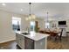 Modern kitchen features an island with quartz countertop, stainless steel appliances, and open concept design at 19970 Edwick Dr, Westfield, IN 46074