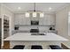 Modern kitchen with quartz countertops, stainless steel appliances, and a center island with seating at 19970 Edwick Dr, Westfield, IN 46074