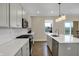 Bright kitchen featuring white cabinets, subway tile backsplash, stainless steel appliances and an island with quartz countertop at 19970 Edwick Dr, Westfield, IN 46074