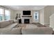 Comfortable living room featuring a fireplace, mounted TV, and plenty of natural light from large windows at 19970 Edwick Dr, Westfield, IN 46074