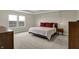 Relaxing primary bedroom with a large window, modern lighting, and neutral decor at 19970 Edwick Dr, Westfield, IN 46074