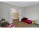 An open playroom featuring a toy kitchen, a sofa, and a rocking horse on vinyl floors at 19970 Edwick Dr, Westfield, IN 46074