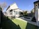 Professionally landscaped backyard featuring artificial turf, patio, concrete paths and fire pit at 2037 Ruckle St, Indianapolis, IN 46202