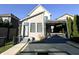 Backyard with a modern hot tub, pergola, patio, concrete paths, and manicured landscaping at 2037 Ruckle St, Indianapolis, IN 46202