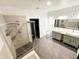 Modern bathroom with double sinks, walk-in shower, and tile floors, creating a sleek and functional space at 2037 Ruckle St, Indianapolis, IN 46202
