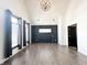 Well-lit bedroom with vaulted ceiling, black accent wall, modern lighting, and large windows providing ample natural light at 2037 Ruckle St, Indianapolis, IN 46202