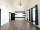 Bright bedroom featuring vaulted ceiling, modern lighting, built-in shelving, and large windows with lots of natural light at 2037 Ruckle St, Indianapolis, IN 46202
