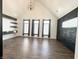 Spacious bedroom with vaulted ceiling, black accent wall, floating shelves, and large windows offering lots of natural light at 2037 Ruckle St, Indianapolis, IN 46202
