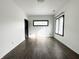 Bright bedroom with hardwood floors and black trim windows at 2037 Ruckle St, Indianapolis, IN 46202