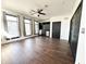 A bright bedroom with a ceiling fan, built-in shelving, and hardwood floors at 2037 Ruckle St, Indianapolis, IN 46202