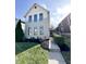 Well-maintained home with a grassy lawn and an inviting walkway at 2037 Ruckle St, Indianapolis, IN 46202