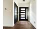 Inviting foyer featuring dark wood floors and a modern front door with sidelight at 2037 Ruckle St, Indianapolis, IN 46202