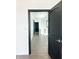 Hallway with hardwood floors and modern lighting, features dark trim and doors, leading to other areas of the home at 2037 Ruckle St, Indianapolis, IN 46202