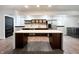 Open kitchen with a center island, stainless steel appliances, and dark cabinets at 2037 Ruckle St, Indianapolis, IN 46202