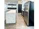 Modern kitchen showcasing stainless steel appliances, a center island with marble countertop, and wood floors at 2037 Ruckle St, Indianapolis, IN 46202