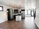 Open-concept kitchen with black cabinets, stainless appliances, and a stone-clad island at 2037 Ruckle St, Indianapolis, IN 46202