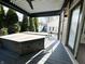 Covered patio with a hot tub, ceiling fan, and view of the backyard and guest house at 2037 Ruckle St, Indianapolis, IN 46202