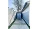 A concrete driveway leads to a grey storage shed between houses at 2037 Ruckle St, Indianapolis, IN 46202