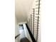 Staircase with a sleek black railing and modern, geometric wine racks at 2037 Ruckle St, Indianapolis, IN 46202