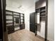 Custom walk-in closet with dark wood shelving, drawers, and vanity area, providing ample storage and organization at 2037 Ruckle St, Indianapolis, IN 46202