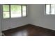 Empty bedroom with hardwood floors and a bright window overlooking the outdoors at 2194 N Riley Ave, Indianapolis, IN 46218