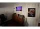 Bedroom with a TV, a dresser, and a poster on the door at 2194 N Riley Ave, Indianapolis, IN 46218