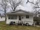 Modest single-story home with vinyl siding, front porch, and a small accessibility ramp at 2194 N Riley Ave, Indianapolis, IN 46218