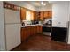 Well-lit kitchen with wood cabinets, modern appliances, and durable flooring at 2194 N Riley Ave, Indianapolis, IN 46218
