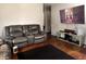 Cozy living room with hardwood floors, a couch, a TV, and a modern media console at 2194 N Riley Ave, Indianapolis, IN 46218