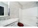 Bright bathroom features modern, neutral tiling surrounding the bathtub and a vanity with marble countertop at 2885 Holiday Way, Greenwood, IN 46143