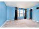 Bright and airy bedroom with blue walls, soft carpet, and natural light at 2885 Holiday Way, Greenwood, IN 46143